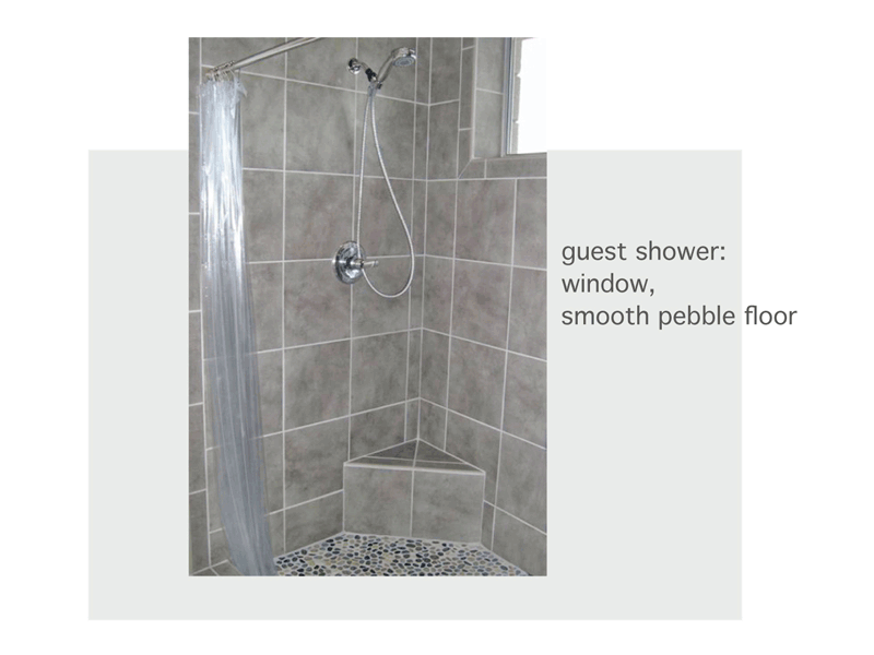 guest shower with natural light and smooth pebble floor